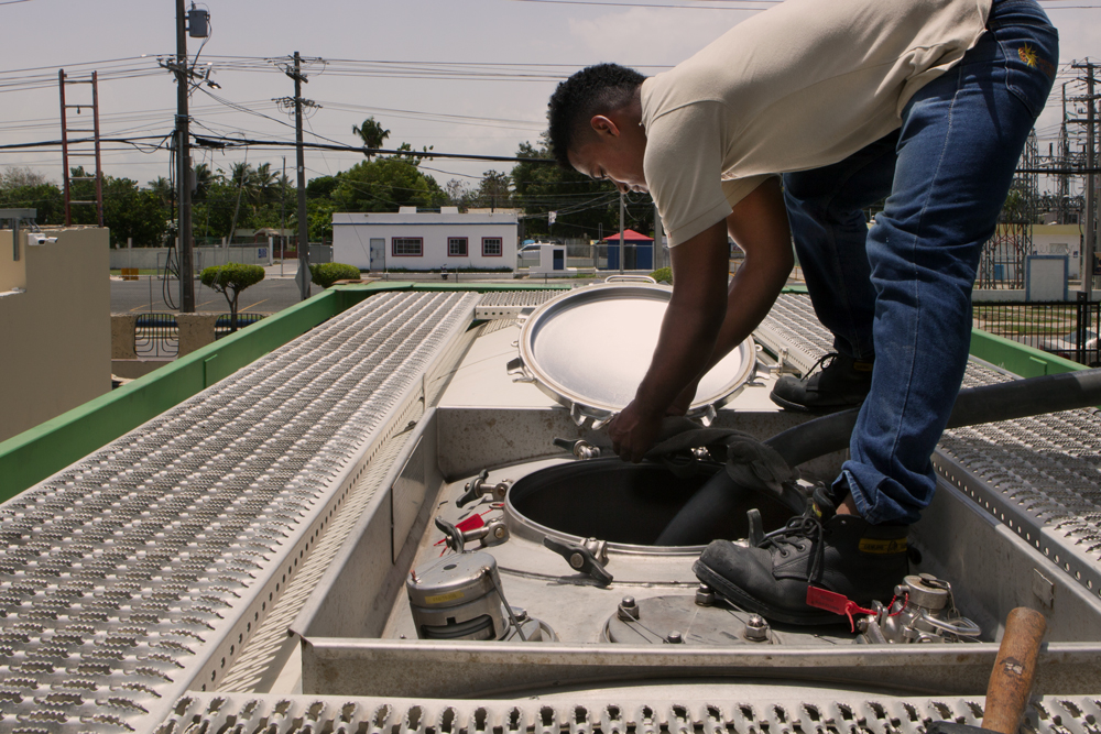 Worker filling tank